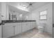 Bathroom features a double vanity with granite counters and a large mirror at 9810 San Sebastian Way, Port Richey, FL 34668