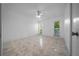 Bright, spacious bedroom with tile flooring, ceiling fan, and view to the outside at 9810 San Sebastian Way, Port Richey, FL 34668