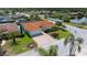Well-maintained home with lush landscaping, a brick driveway, and a two-car garage in a serene setting at 9810 San Sebastian Way, Port Richey, FL 34668