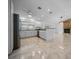 Spacious kitchen open to the living space with white cabinetry and granite countertops at 9810 San Sebastian Way, Port Richey, FL 34668