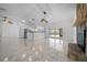 Open concept living area with kitchen, fireplace, and sliding glass door to the patio at 9810 San Sebastian Way, Port Richey, FL 34668