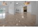 Open living room with tile floors, ceiling fans, and fireplace at 9810 San Sebastian Way, Port Richey, FL 34668
