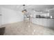 Open-concept living space with tile flooring and views into the kitchen at 9810 San Sebastian Way, Port Richey, FL 34668