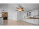 Open living room featuring stone fireplace and views into the kitchen at 9810 San Sebastian Way, Port Richey, FL 34668