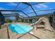 The pristine enclosed pool offers a water slide for the  at 9810 San Sebastian Way, Port Richey, FL 34668