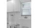 Utility room with white cabinetry and sink at 9810 San Sebastian Way, Port Richey, FL 34668