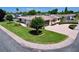Beautiful aerial view of a well-kept property featuring manicured lawns and a curved driveway at 10111 Glen Moor Ln, Port Richey, FL 34668