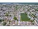 Extensive aerial view of residential area near a lake, showcasing the community's layout at 10111 Glen Moor Ln, Port Richey, FL 34668