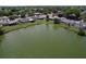 Beautiful aerial shot showcasing homes along a lake, highlighting outdoor living and green spaces at 10111 Glen Moor Ln, Port Richey, FL 34668