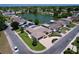 Scenic aerial view of homes near a picturesque lake with lush greenery and mature trees at 10111 Glen Moor Ln, Port Richey, FL 34668