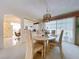 Open concept dining area with kitchen view and bright natural light at 10111 Glen Moor Ln, Port Richey, FL 34668