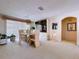 Formal dining area featuring elegant chandelier, custom built-in cabinet, and sliding glass doors at 10111 Glen Moor Ln, Port Richey, FL 34668