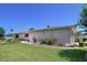 Well-maintained house featuring manicured landscaping, flowerbeds, and a green lawn at 10111 Glen Moor Ln, Port Richey, FL 34668