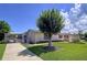 Charming home featuring a lush, green lawn and mature landscaping in the front yard at 10111 Glen Moor Ln, Port Richey, FL 34668