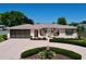 Charming home featuring a well-manicured front yard with attractive landscaping and a welcoming entrance at 10111 Glen Moor Ln, Port Richey, FL 34668