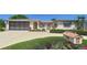 Charming single-story home featuring a well-manicured front yard and attached two-car garage at 10111 Glen Moor Ln, Port Richey, FL 34668