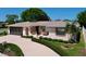 Charming single-story home featuring a well-manicured front yard and attached two-car garage at 10111 Glen Moor Ln, Port Richey, FL 34668
