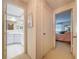 Bright hallway featuring a bathroom with vanity and a bedroom with soft, natural light at 10111 Glen Moor Ln, Port Richey, FL 34668