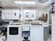 Functional laundry room with washer, dryer, storage cabinets and a utility sink at 10111 Glen Moor Ln, Port Richey, FL 34668