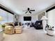 Spacious living room with a large TV, neutral tones, and stylish black accents at 10111 Glen Moor Ln, Port Richey, FL 34668