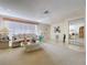 Bright living room with plush carpet, a comfortable sofa, and stylish décor, offering a welcoming space at 10111 Glen Moor Ln, Port Richey, FL 34668