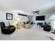 Comfortable living room with a large TV, neutral tones, and modern furnishings at 10111 Glen Moor Ln, Port Richey, FL 34668