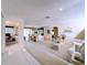 Bright living room with white carpet, archways, decorative statues, and elegant decor at 10111 Glen Moor Ln, Port Richey, FL 34668