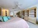 Main bedroom with a ceiling fan, large closets, and a built-in desk and drawers at 10111 Glen Moor Ln, Port Richey, FL 34668