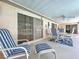 Relaxing covered patio with comfortable seating and a view of the pool area, perfect for outdoor entertaining at 10111 Glen Moor Ln, Port Richey, FL 34668
