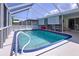 Relaxing screened-in pool area featuring comfortable seating and a refreshing pool at 10111 Glen Moor Ln, Port Richey, FL 34668