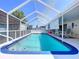 Relaxing screened-in pool area featuring comfortable seating and a refreshing pool at 10111 Glen Moor Ln, Port Richey, FL 34668