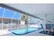 Relaxing screened-in pool area featuring comfortable seating and a refreshing pool at 10111 Glen Moor Ln, Port Richey, FL 34668