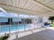 Enclosed pool area with a clear pool and a covered patio, offering a private oasis for relaxation at 10111 Glen Moor Ln, Port Richey, FL 34668