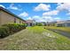 Backyard view of the property including neighboring homes and a scenic pond at 10155 Duffy Cir, Weeki Wachee, FL 34613