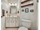 Cozy bathroom with decorative wallpaper, wall sconces, and stylish mirror at 10155 Duffy Cir, Weeki Wachee, FL 34613