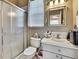 Bathroom with glass enclosed shower, toilet, and vanity with storage at 10155 Duffy Cir, Weeki Wachee, FL 34613