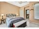 Bedroom features neutral tones, a comfortable bed and an ensuite bathroom at 10155 Duffy Cir, Weeki Wachee, FL 34613