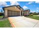 A well-maintained driveway leads to an attached two-car garage in a charming home at 10155 Duffy Cir, Weeki Wachee, FL 34613
