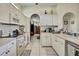 Bright galley kitchen with white cabinets and appliances at 10155 Duffy Cir, Weeki Wachee, FL 34613