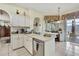 Kitchen with a sink, stainless steel dishwasher, and a view of the outdoor pool at 10155 Duffy Cir, Weeki Wachee, FL 34613