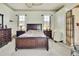 The main bedroom has a large bed, neutral walls, and bright windows with blinds at 10155 Duffy Cir, Weeki Wachee, FL 34613