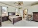 A cozy main bedroom features wood furniture, neutral walls, and an ensuite bathroom at 10155 Duffy Cir, Weeki Wachee, FL 34613