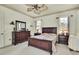 A cozy main bedroom features wood furniture, neutral walls, and bright windows with blinds at 10155 Duffy Cir, Weeki Wachee, FL 34613