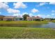 Scenic backyard view of a pond and neighboring properties in a well-maintained community at 10155 Duffy Cir, Weeki Wachee, FL 34613