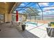 Relaxing screened-in pool with lounge chairs and patio furniture creating an outdoor oasis at 10155 Duffy Cir, Weeki Wachee, FL 34613
