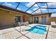 Home features a beautiful screened-in pool, with brick patio, and outdoor seating at 10155 Duffy Cir, Weeki Wachee, FL 34613