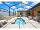 Outdoor pool with screened enclosure, brick patio and lounge chairs at 10155 Duffy Cir, Weeki Wachee, FL 34613