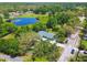 Aerial view showing home's proximity to pond and green landscape at 10301 Nina Ct, New Port Richey, FL 34654