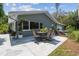 Inviting outdoor patio featuring flagstone pavers with dining set and well manicured landscaping at 10301 Nina Ct, New Port Richey, FL 34654