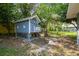 Backyard showing chicken coop and surrounding trees at 10301 Nina Ct, New Port Richey, FL 34654